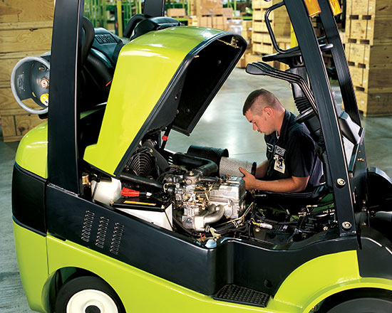 Operator putting a new Clark forklift air filter on his Clark lift truck